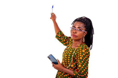 a beautiful mature businesswoman in traditional attire standing in a room and giving class using...