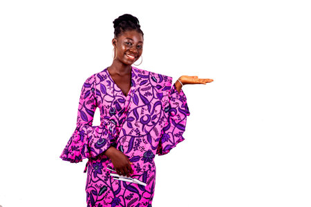 portrait of a beautiful young businesswoman wearing a traditional loincloth and showing empty space on the palm while smiling.の写真素材