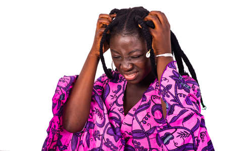 young beautiful african woman with braids standing over white background remembering something important forgotten.の写真素材