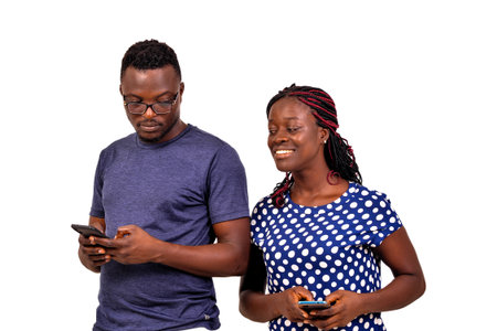 Image of curious young woman using a mobile phone and spying on her boyfriend's cell phone.
