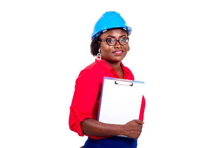 portrait of a beautiful adult female engineer wearing blue safety helmet and holding clipboard while smiling.の写真素材