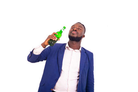 portrait of a handsome young businessman wearing an elegant suit and holding a bottle of beer in his hand.の写真素材