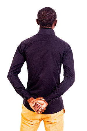 back view of young businessman in black shirt with his hands crossed.
