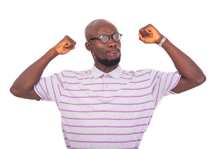young business man wearing his glasses and showing his biceps while smiling.