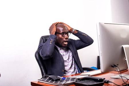 young surprised business man with hands on head in looking at laptop screen.