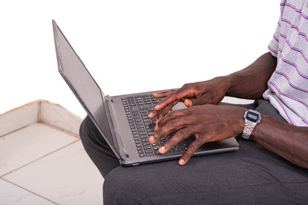 hands of a young man typing on the laptop keyboard.の写真素材