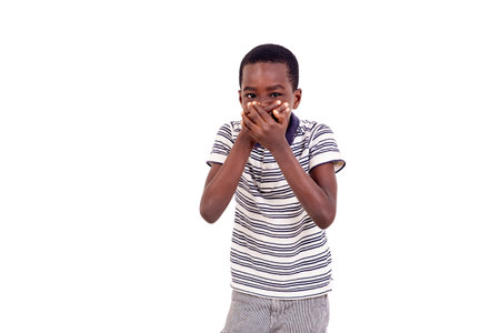 young boy with hands over mouth to prevent vomiting because he was nauseous.の写真素材