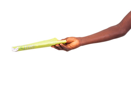 child's hand holding a notebook on white background.の写真素材