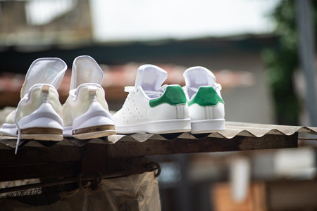 pretty pairs of tennis shoes placed on a roof.のeditorial素材