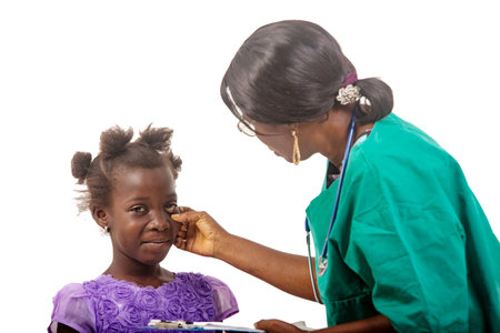 a beautiful nurse in glasses standing on a white background consulting a patient.の写真素材