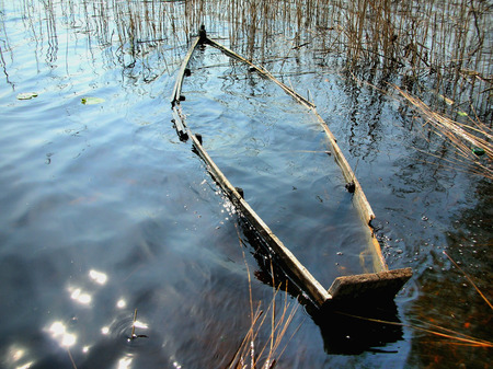 Old Sunken Wooden Fishing Boat In River.の写真素材