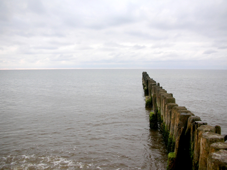 Old wooden breakwater on the Baltic Sea in Lithuaniaの写真素材