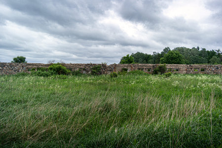 Ruins of old estate buildings made from red brick and stone.の写真素材