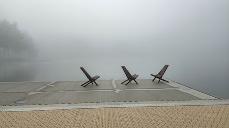 Three empty chairs on a foggy dock. Nord Europeの写真素材