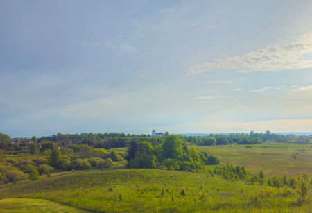 Expansive view of farmland and natural landscape in late afternoon light over rural countryside. North Europe, Lithuaniaの写真素材