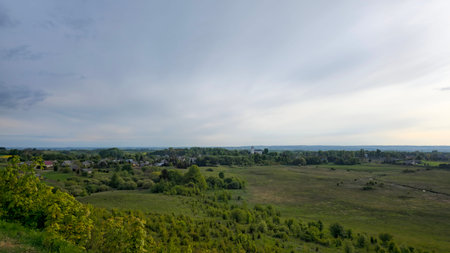 Expansive view of farmland and natural landscape in late afternoon light over rural countryside....