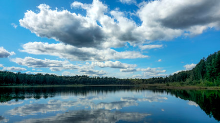 Serene lake reflecting a cloudy sky. Nord Europe