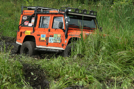 UKRAINE - JULY 28 - Land Rover Defender stuck in the swamp during a race on July 28, 2015 in Ukraine.のeditorial素材