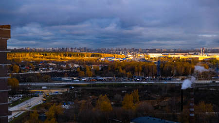 Autumn road from the height to the highway roadway.Gloomy sky.の写真素材