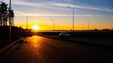 Sunset on the road.Autumn sky.Cars are on the way.Life on the road.の写真素材