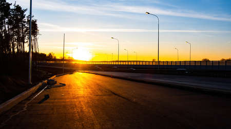 Sunset on the road.Autumn sky.Yellow sun.Cars are on the way.Life is expensive.の写真素材