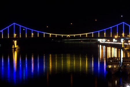 Striking a bridge across the river. The bridge in the center of Kyiv. Bright bridge across the Dnieper River.の写真素材