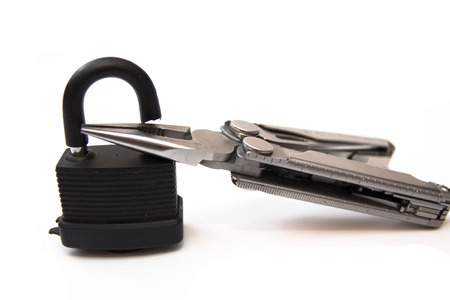 Broken lock and pliers on a white background. Insulator.の写真素材