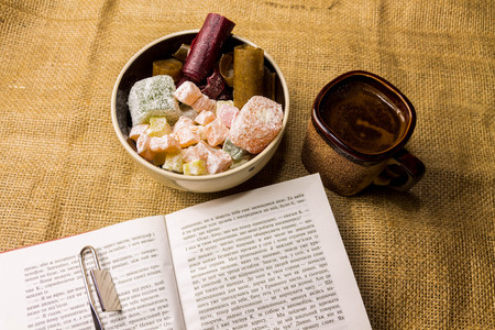 Reading a book with coffee and sweets. Coffee and oriental sweets.の写真素材