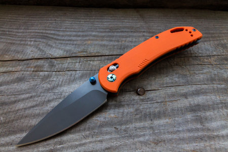 Knife on a wooden background. Knife diagonally. View from above.