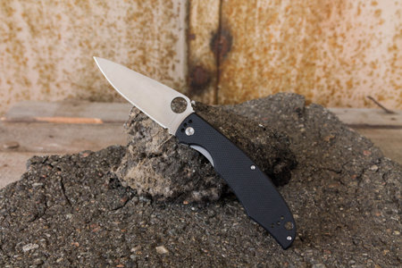 Pocket knife with a hole in the blade. Black knife.