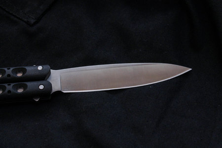 Knife blade on black background. Black handle and white blade.の写真素材