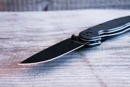 Kind of knife at an angle. Blade of knife. A sharpened knife.