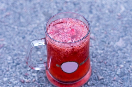 Strawberry tea. Tea with strawberries. Berries of strawberries in tea. Side view.