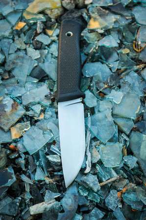 Outdoor knife. Background colorful. Glass. Vertical position.の写真素材