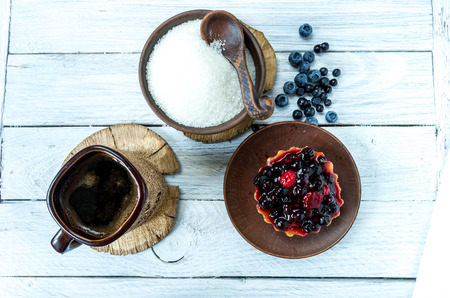 Cup of coffee with a sweet cake with wild berries. Coffee break.の写真素材