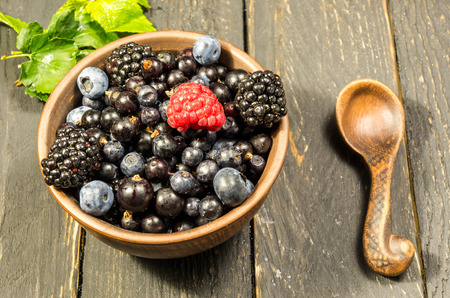 Fresh forest berries with a green leaf. Not like everyone else.の写真素材