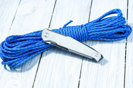 A classic iron knife with an iron grip in folded form. White knife on white background.の写真素材
