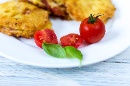 Chops and cherry tomatoes. Dish on a white plate.の写真素材