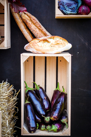 Rural eggplant and homemade bread. Rustic still life.の写真素材