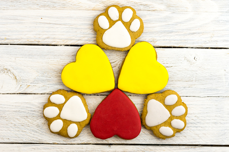 Festive colorful gingerbread. Multicolored hearts. Dog's feetの写真素材