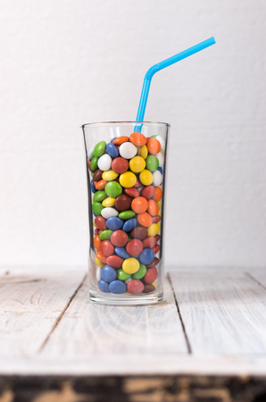 A glass with a colorful drink in the center of the frame.の写真素材