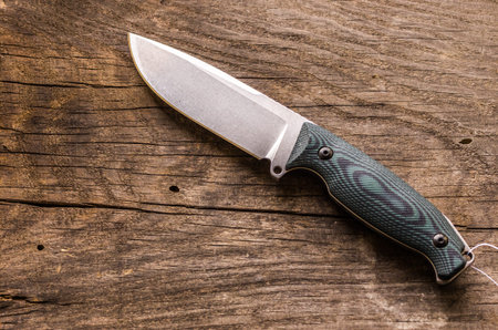 Hunting knife on the right side. Place for text. Place for advertising. Background of an old cracked...
