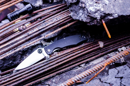 Tactical knife and hand flashlights. Many rusty fixtures. Tactical accessories.