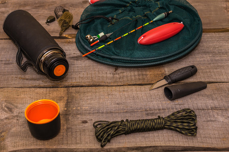 Fishing set. Attributes of a fisherman. Necessary accessories for the fisherman. Wooden background.の写真素材