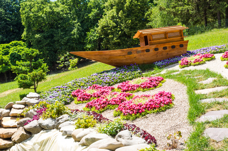 Japanese wooden boat. Boat in the park. Flowers and lawn.の写真素材