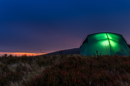 Tourist tent in the evening mountains. Sunset in the mountains.の写真素材