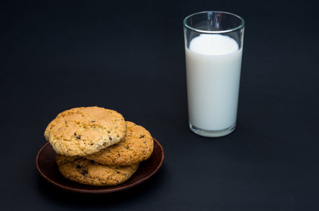 Homemade cookies and homemade milk. Healthy breakfast. Composition in a low key.