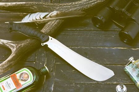 Kyiv, Ukraine April 7, 2018. Hunting composition. Liqueur J germeister and machete Fox Knifeのeditorial素材