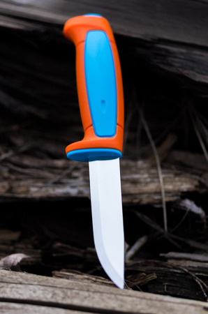 The knife is inserted into an old friable tree. Vertical shot.の写真素材