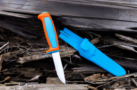 Knife with plastic handle. Bright multi-colored handle. Turquoise sheath.